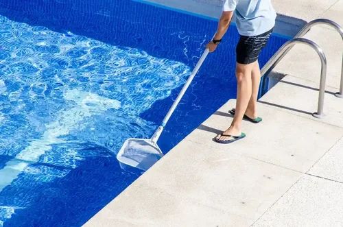 Pool technician cleaning a pool