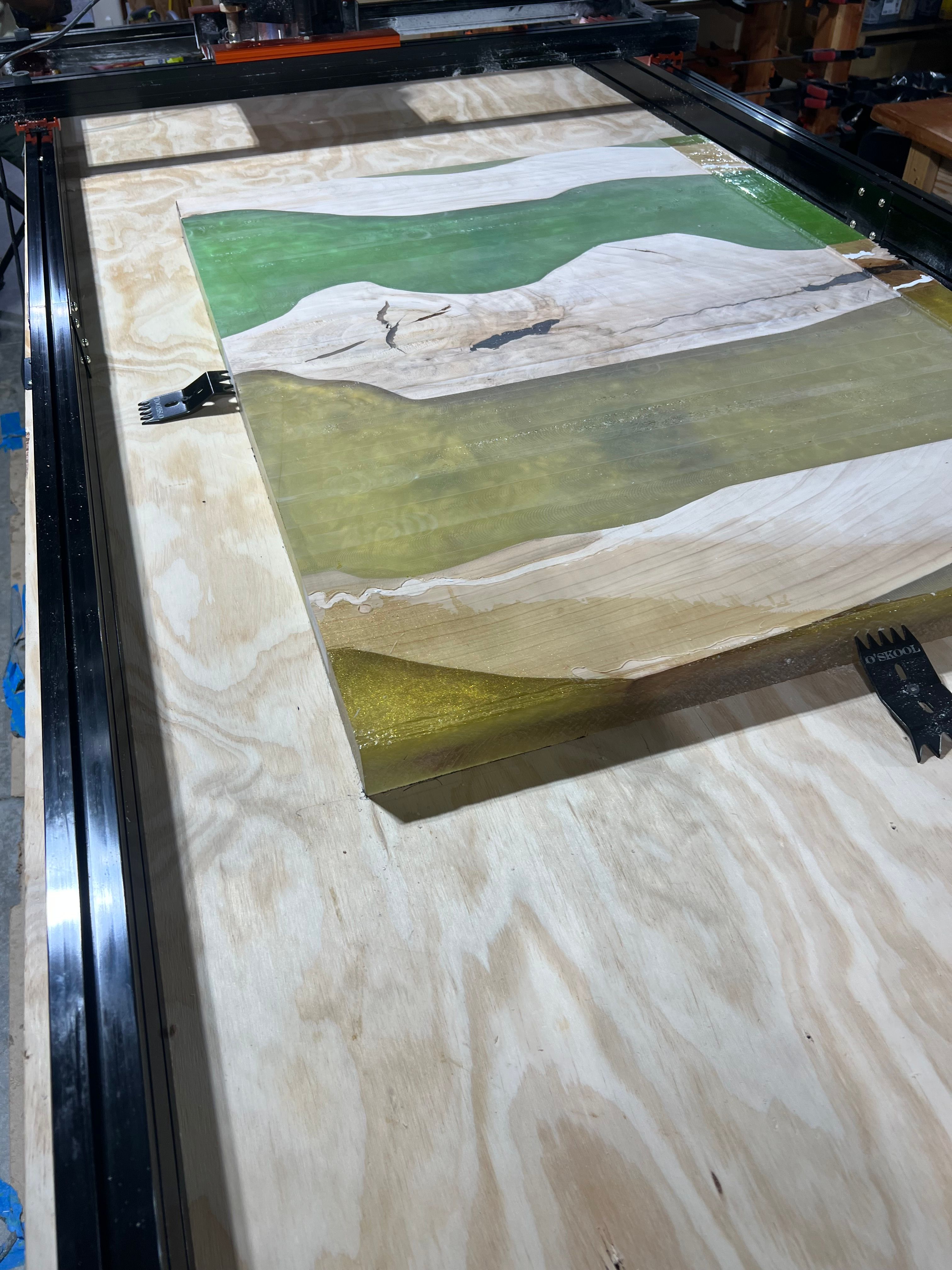 Epoxy resin pour in progress with green and yellow colors