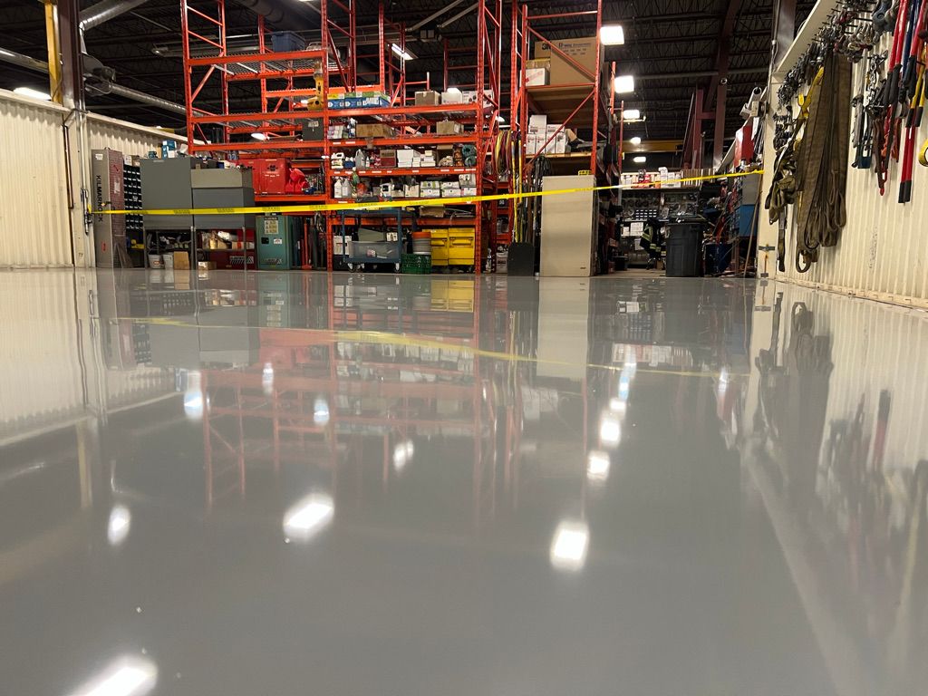 Warehouse storage area with highly reflective epoxy floor, orange shelving and Lean 5S caution tape