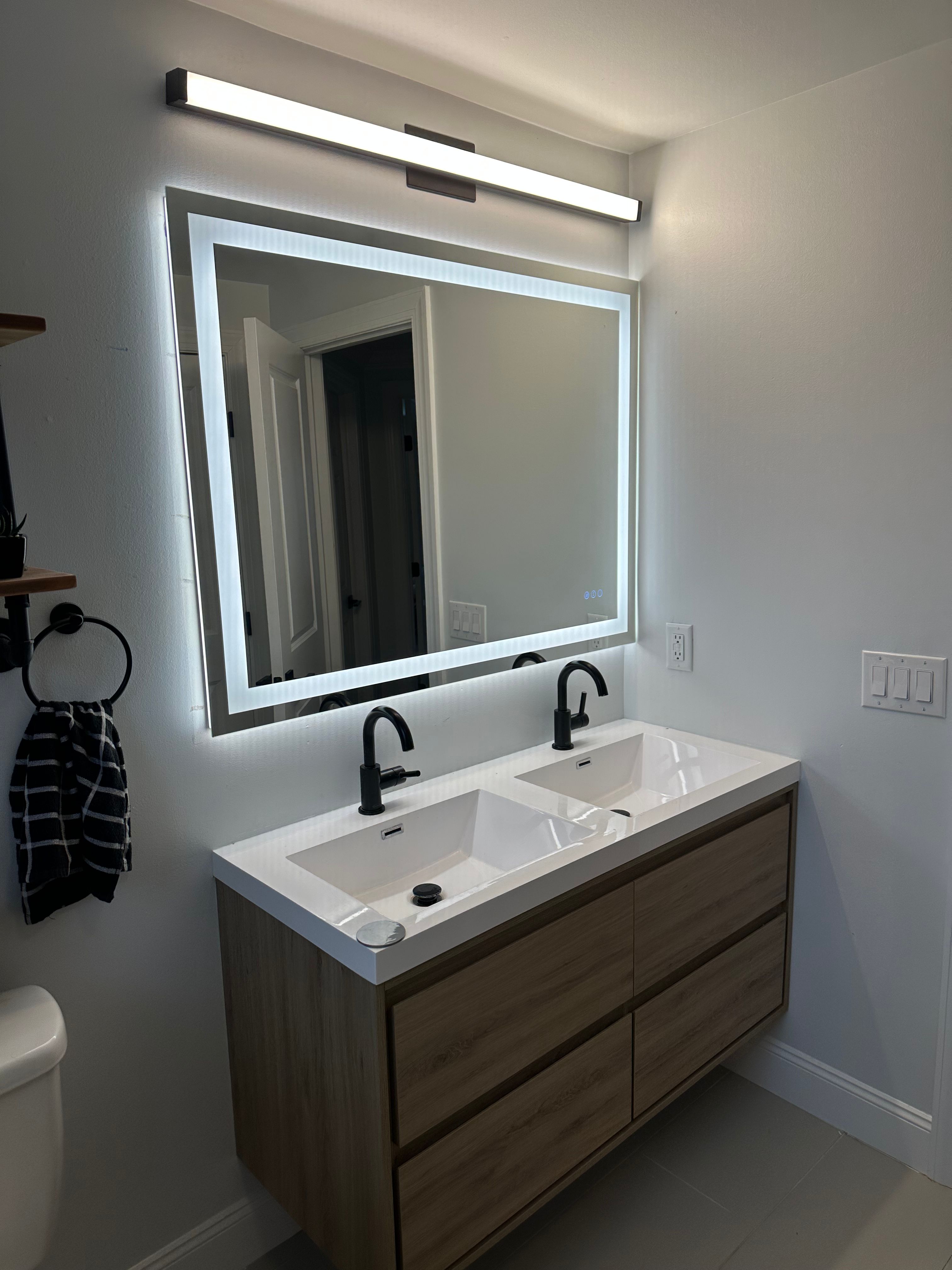 Modern bathroom vanity with LED mirror installation by Premier Electric Rochester NY