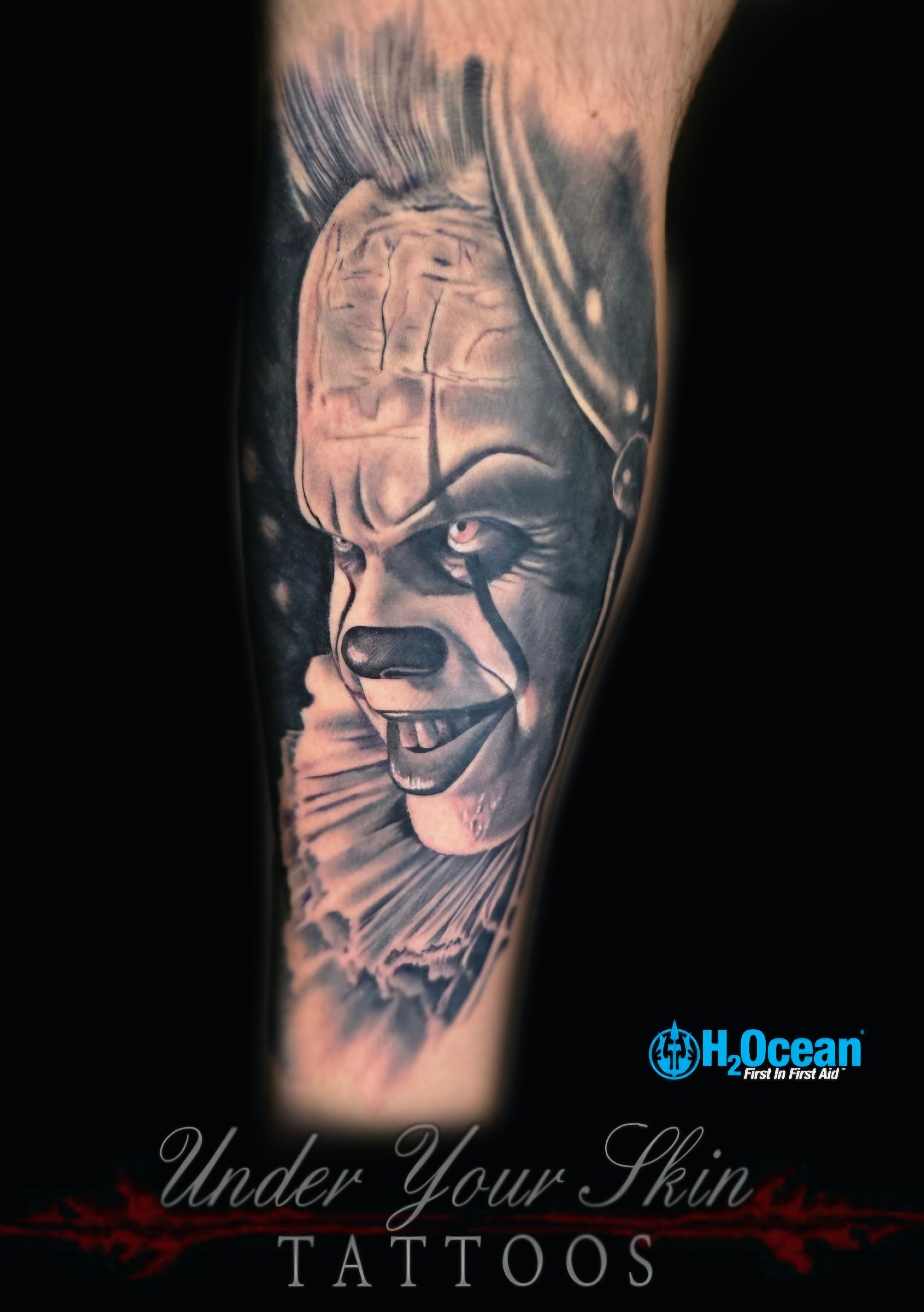 Black and grey sinister clown tattoo by Craig at Under Your Skin Tattoos