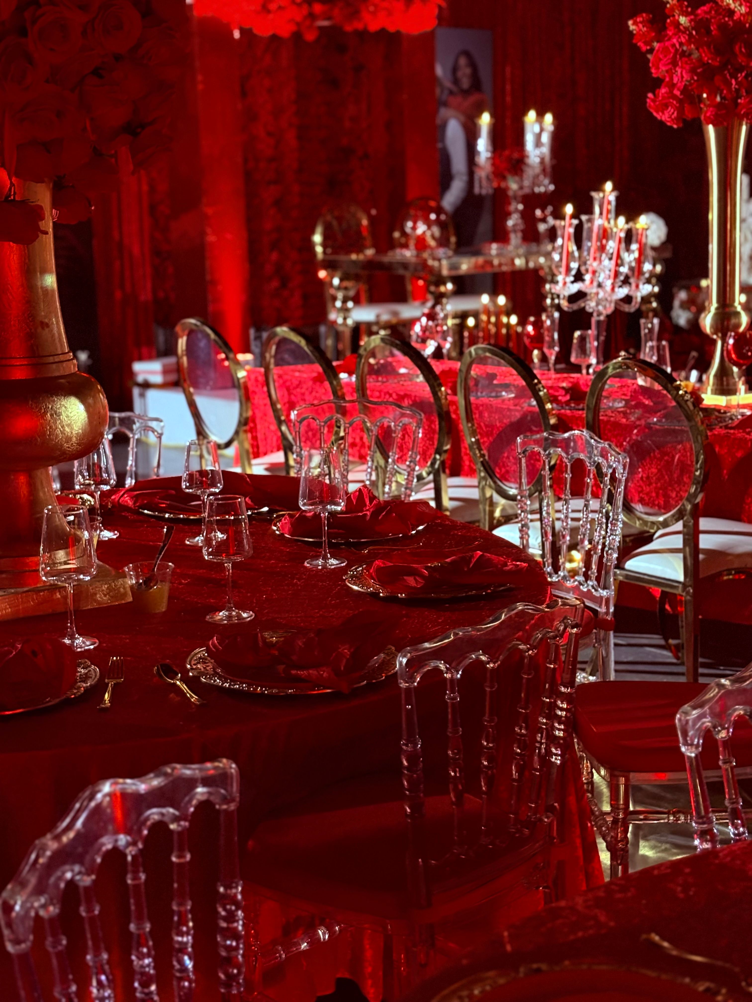 Luxury red wedding reception table with crystal chairs