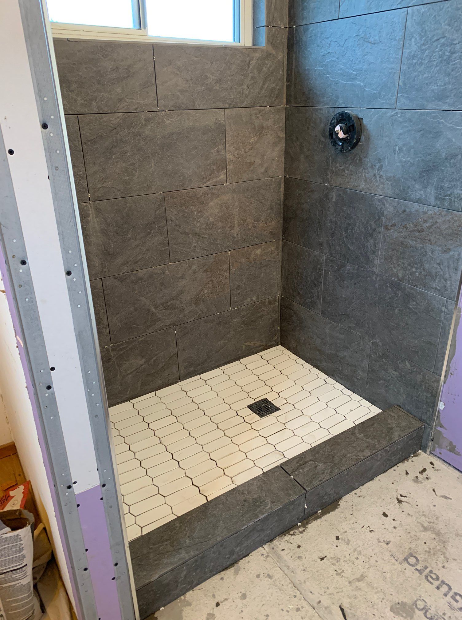 Bathroom shower remodel with dark gray tile