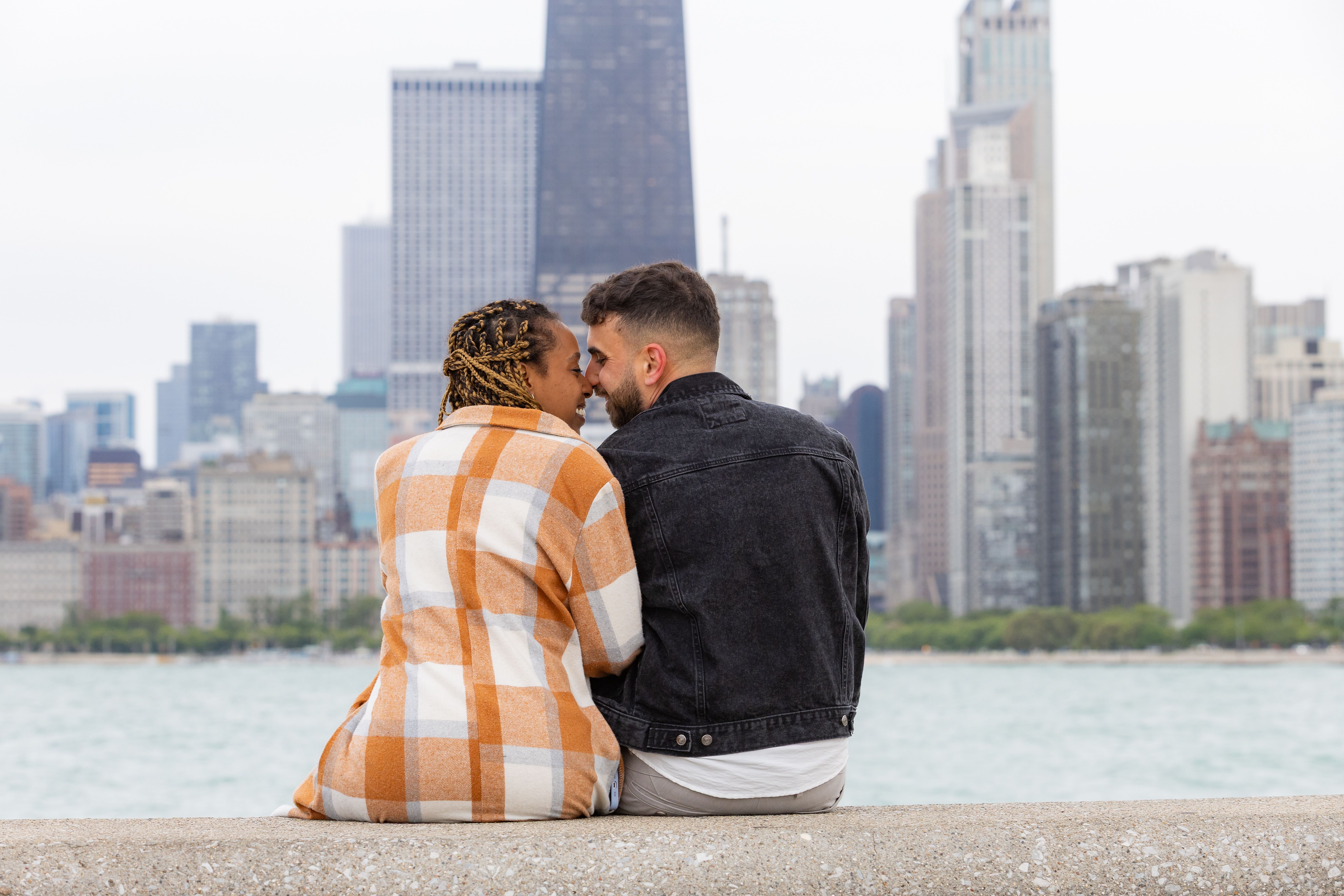 Couple sitting together facing Chicago city skyline