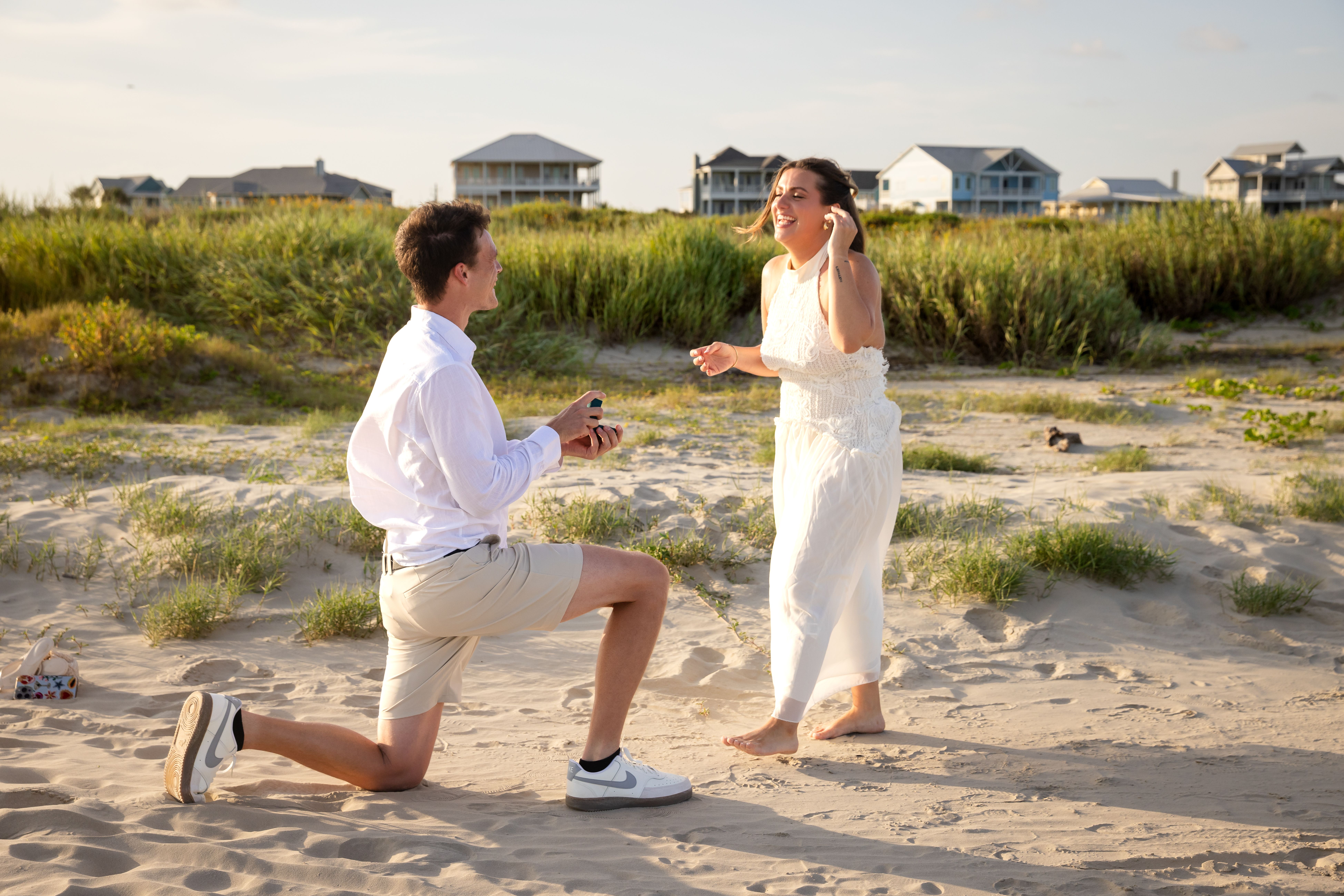 Beach proposal — man kneeling with ring box
