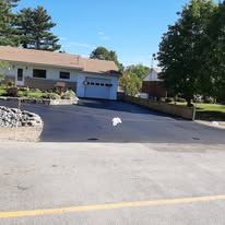 Freshly paved driveway with stone retaining walls
