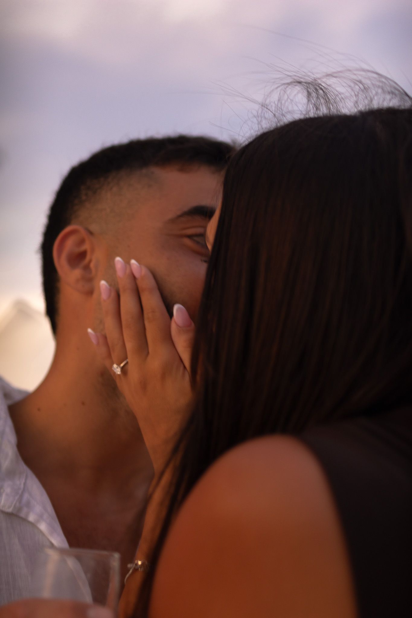 Intimate close-up of couple touching faces with ring