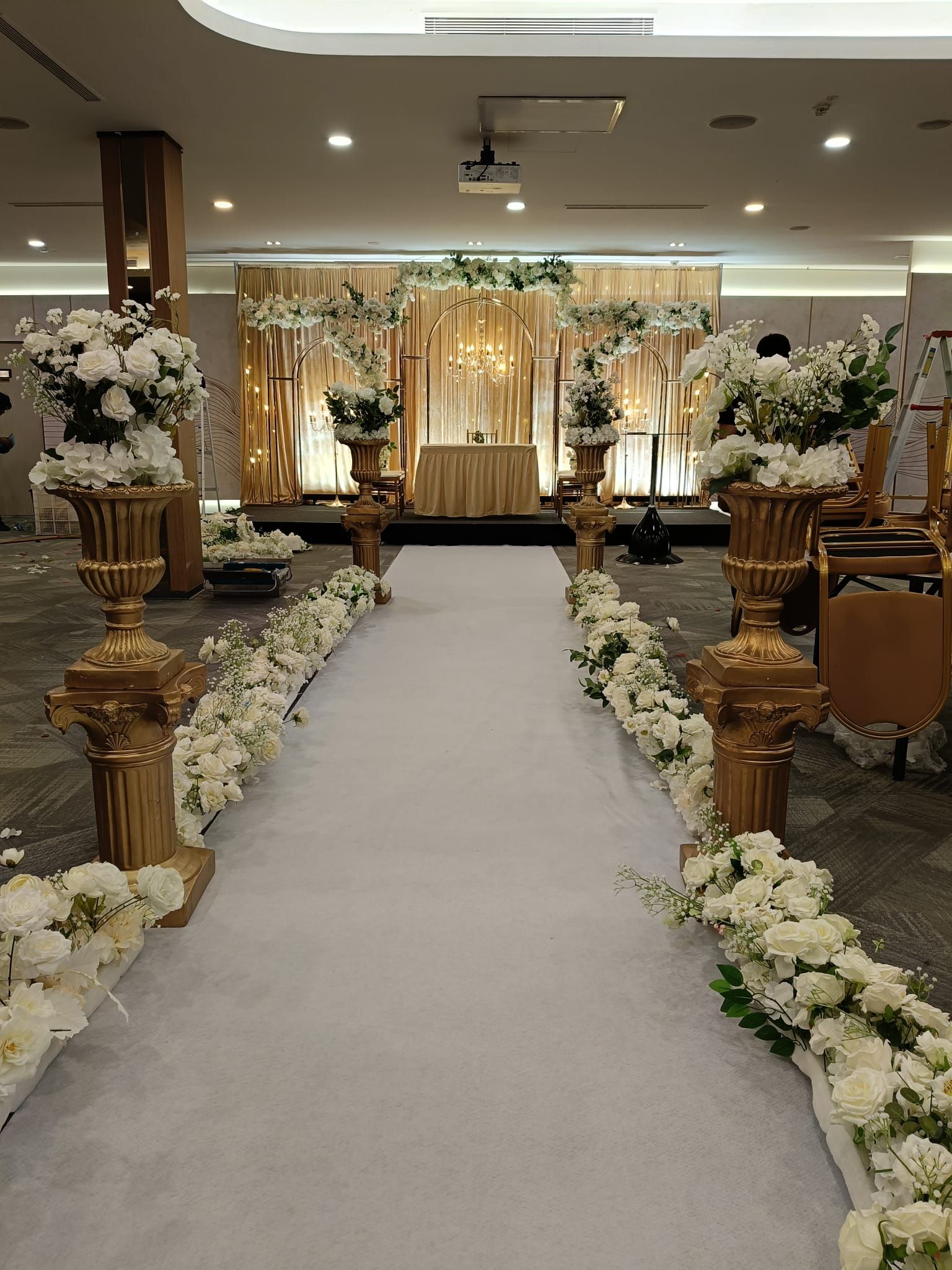 Luxury Indian wedding stage decoration with warm gold lighting