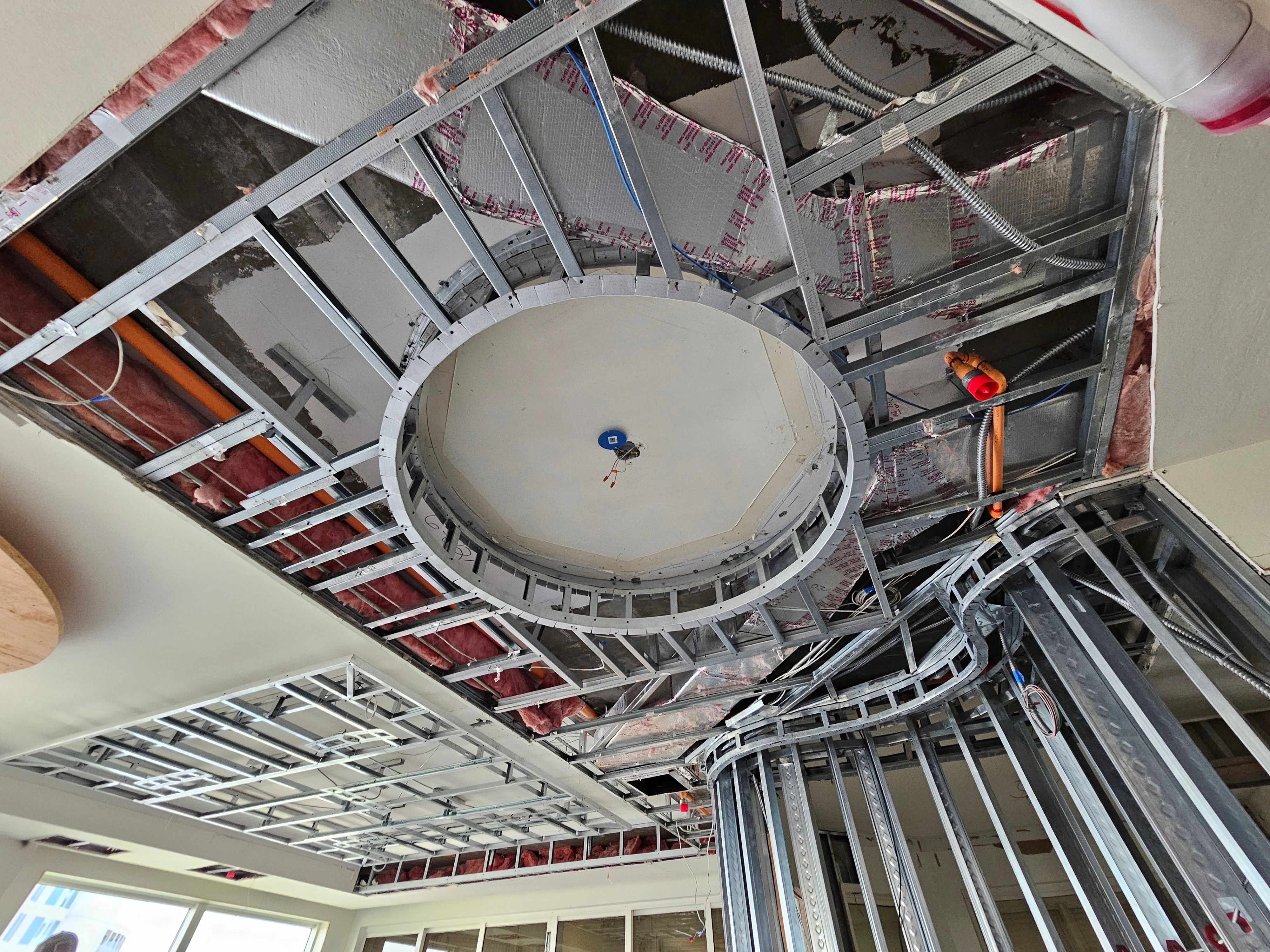 Ceiling framing with wiring and insulation in progress