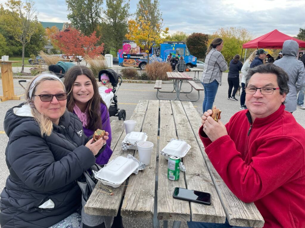 Family enjoying hot dogs and pretzels