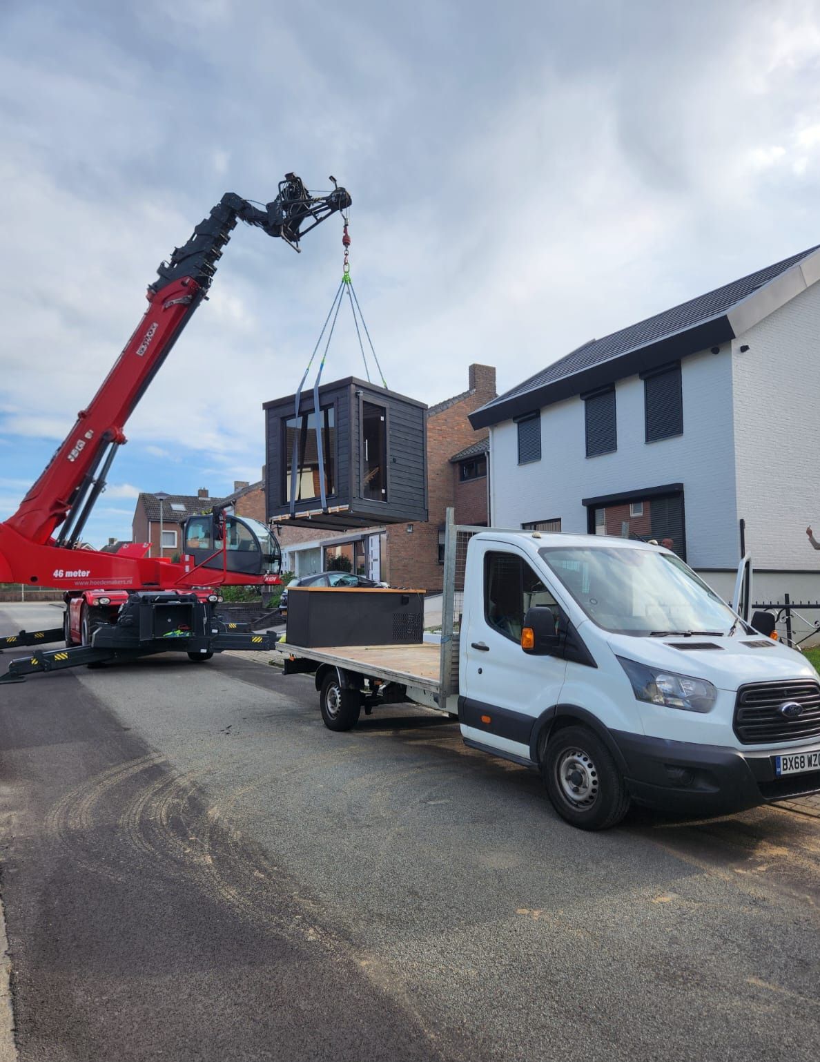 Crane lifting a unit with Medi-Spa truck