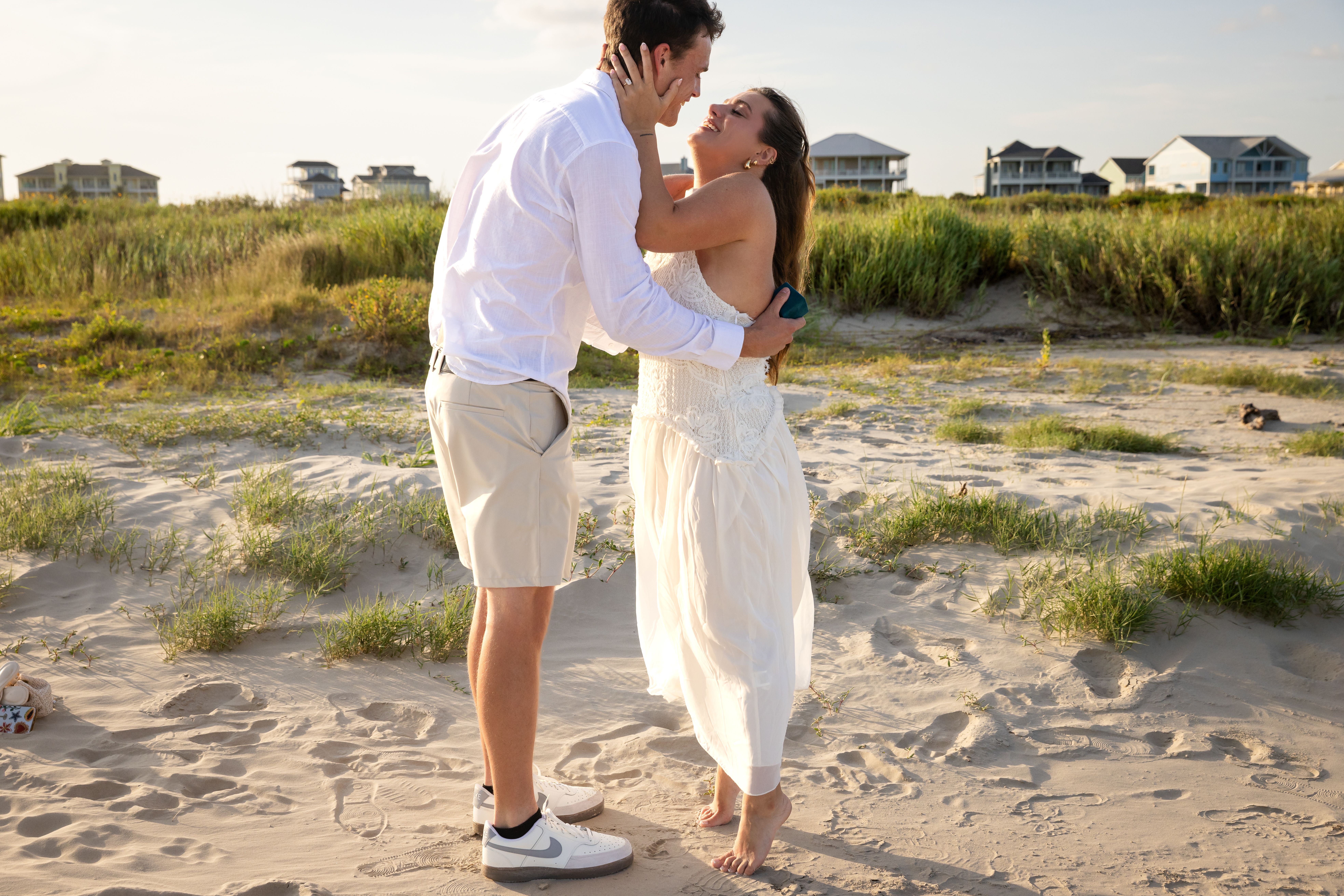 Couple embracing on the beach after proposal