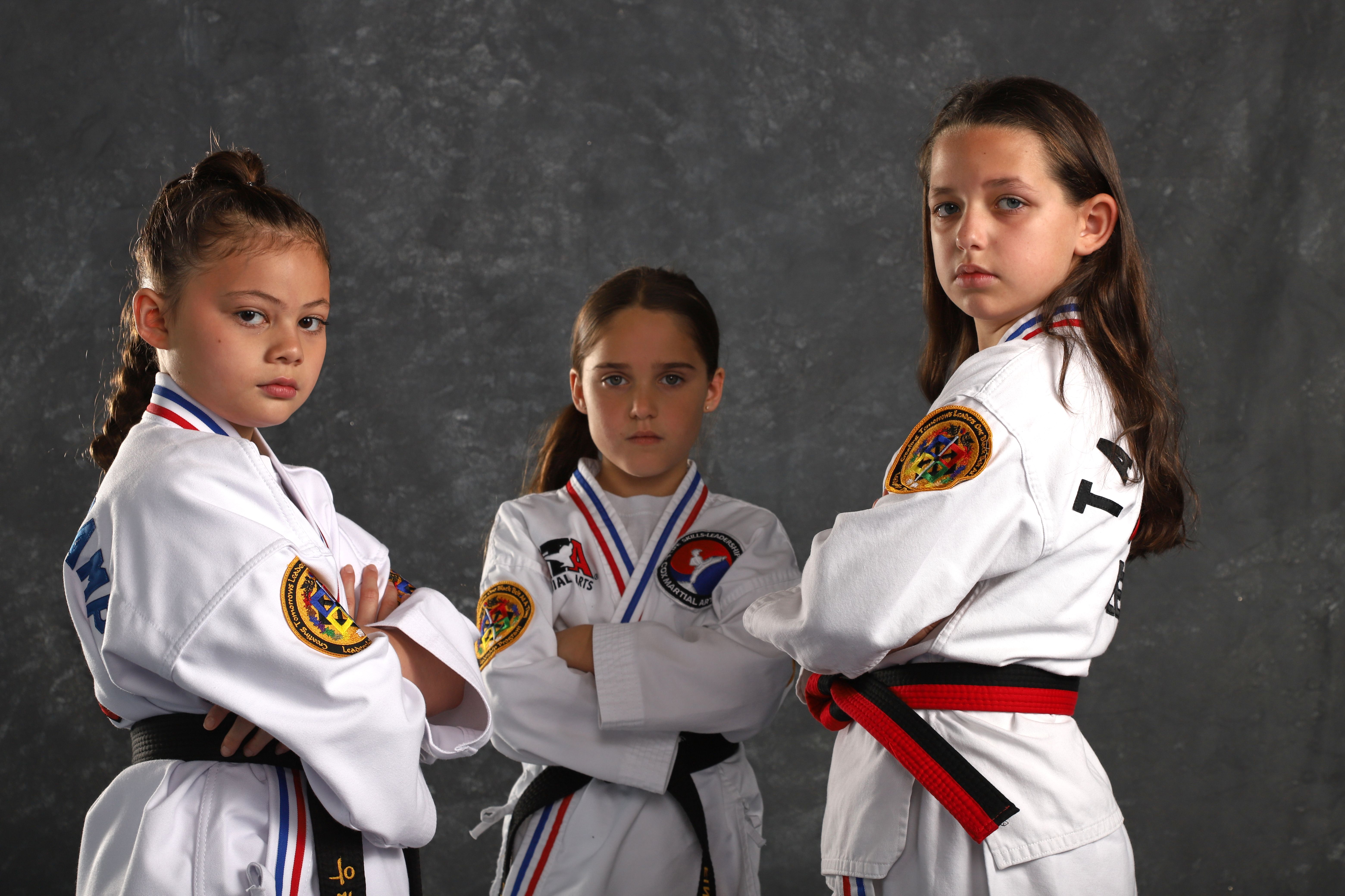 Three black belt students