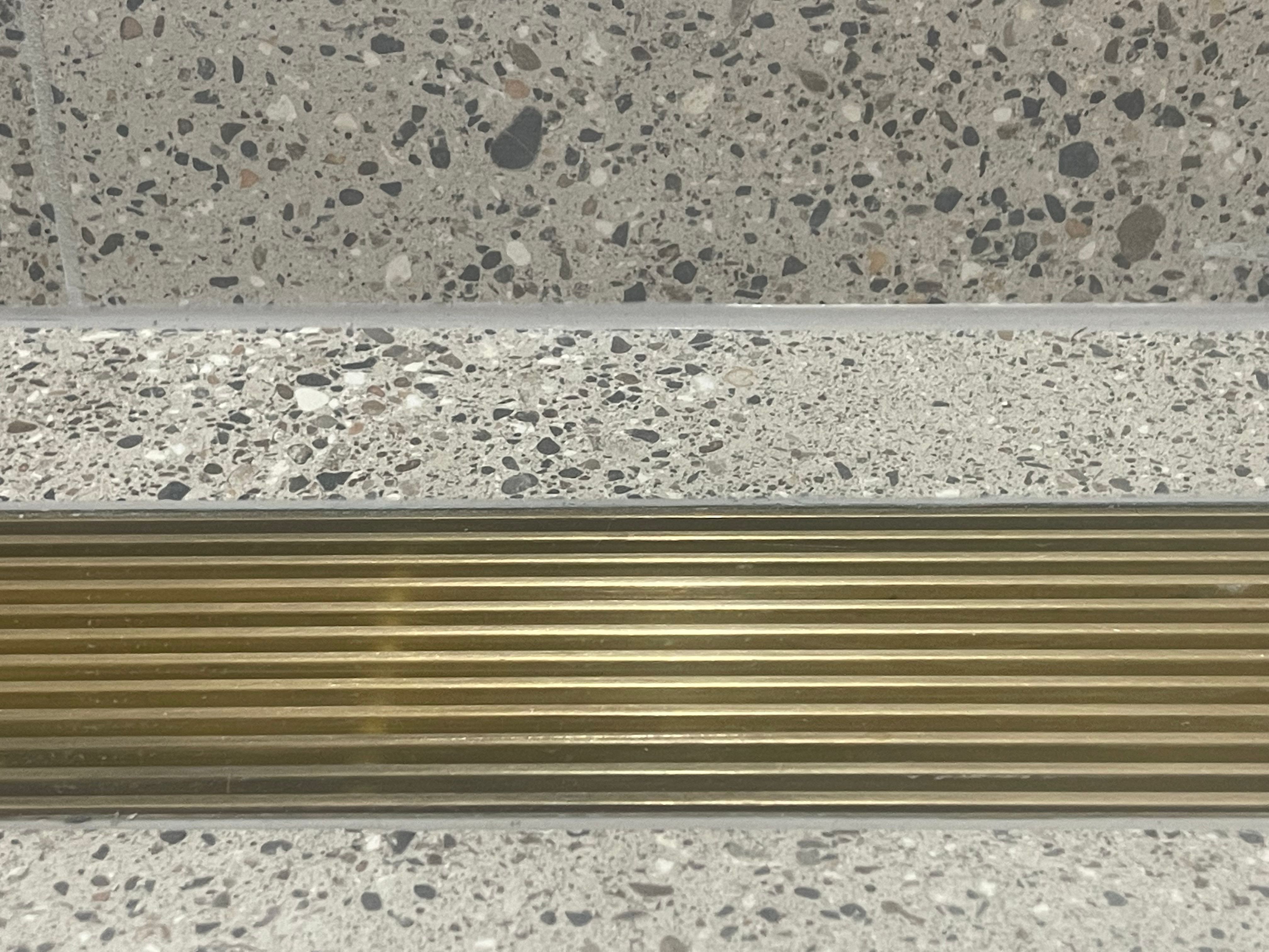 Brass grate in terrazzo floor