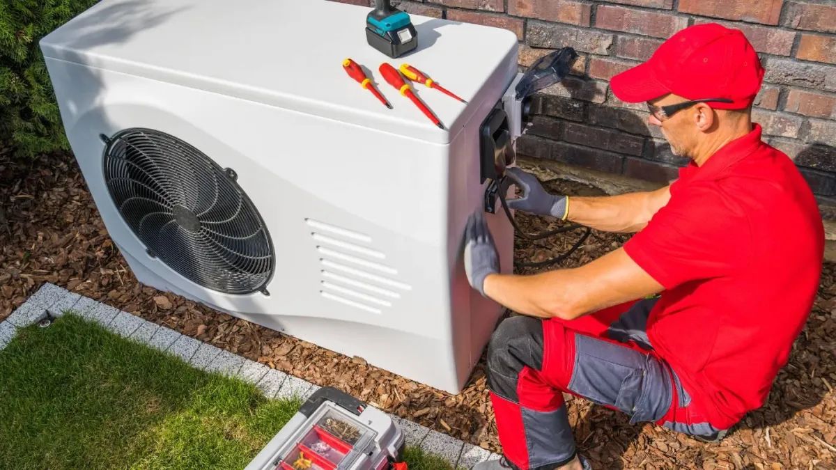 Brandon Hoofard working on an AC unit