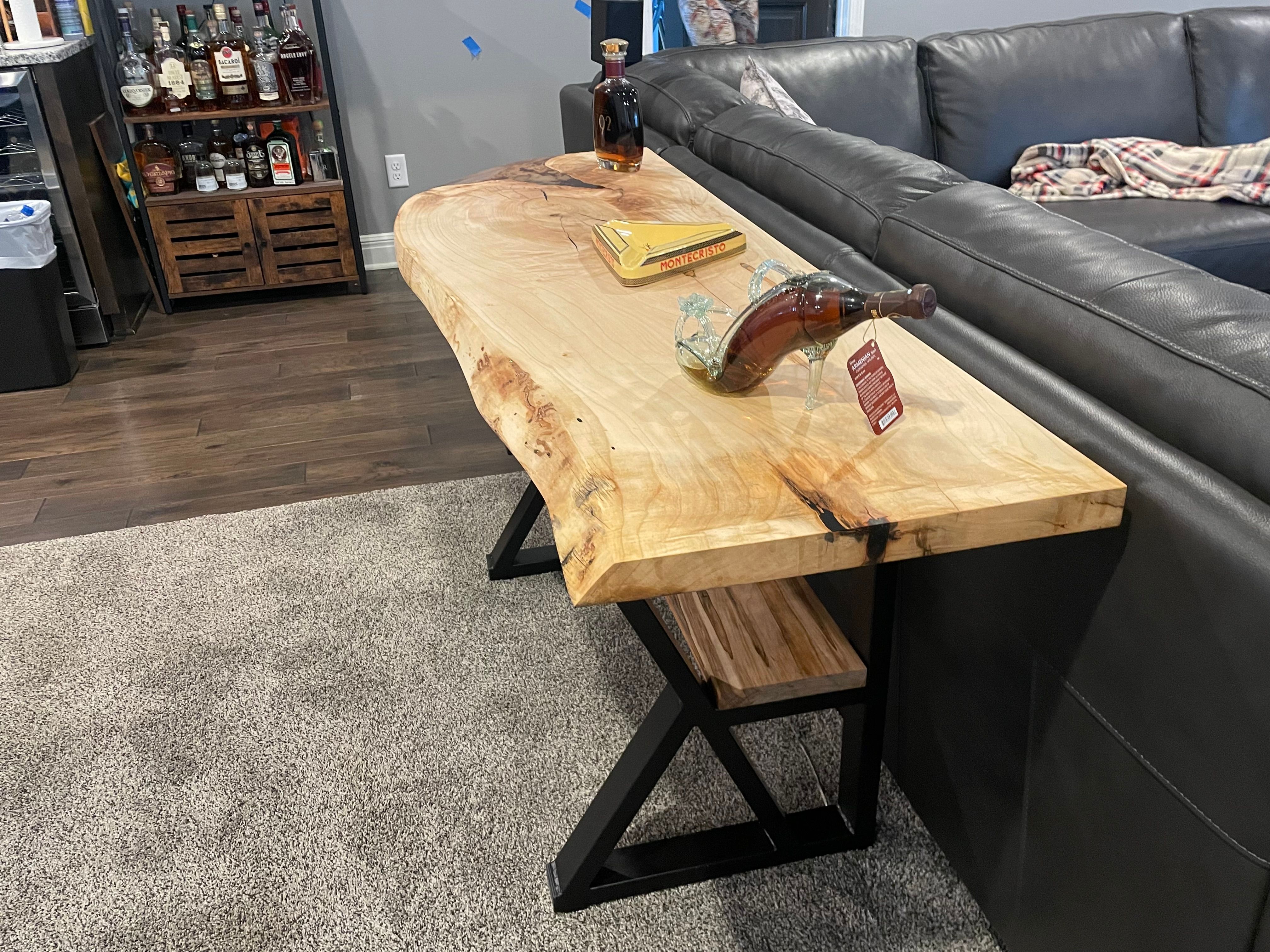 Live edge sofa table with bottles and cigar box display