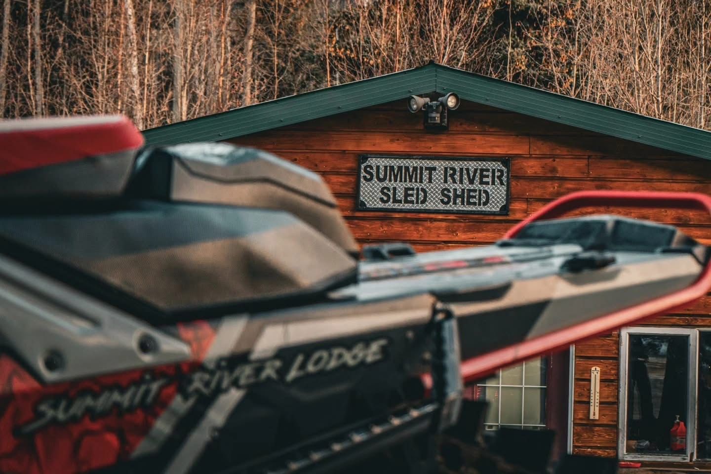 Summit River Lodge Sled Shed and branded snowmobile
