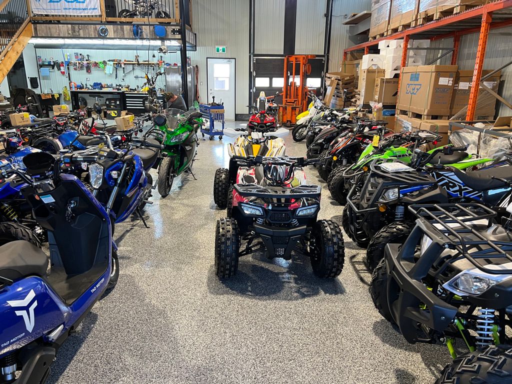 Workshop showroom floor with polished epoxy and a wide range of ATVs and motorcycles