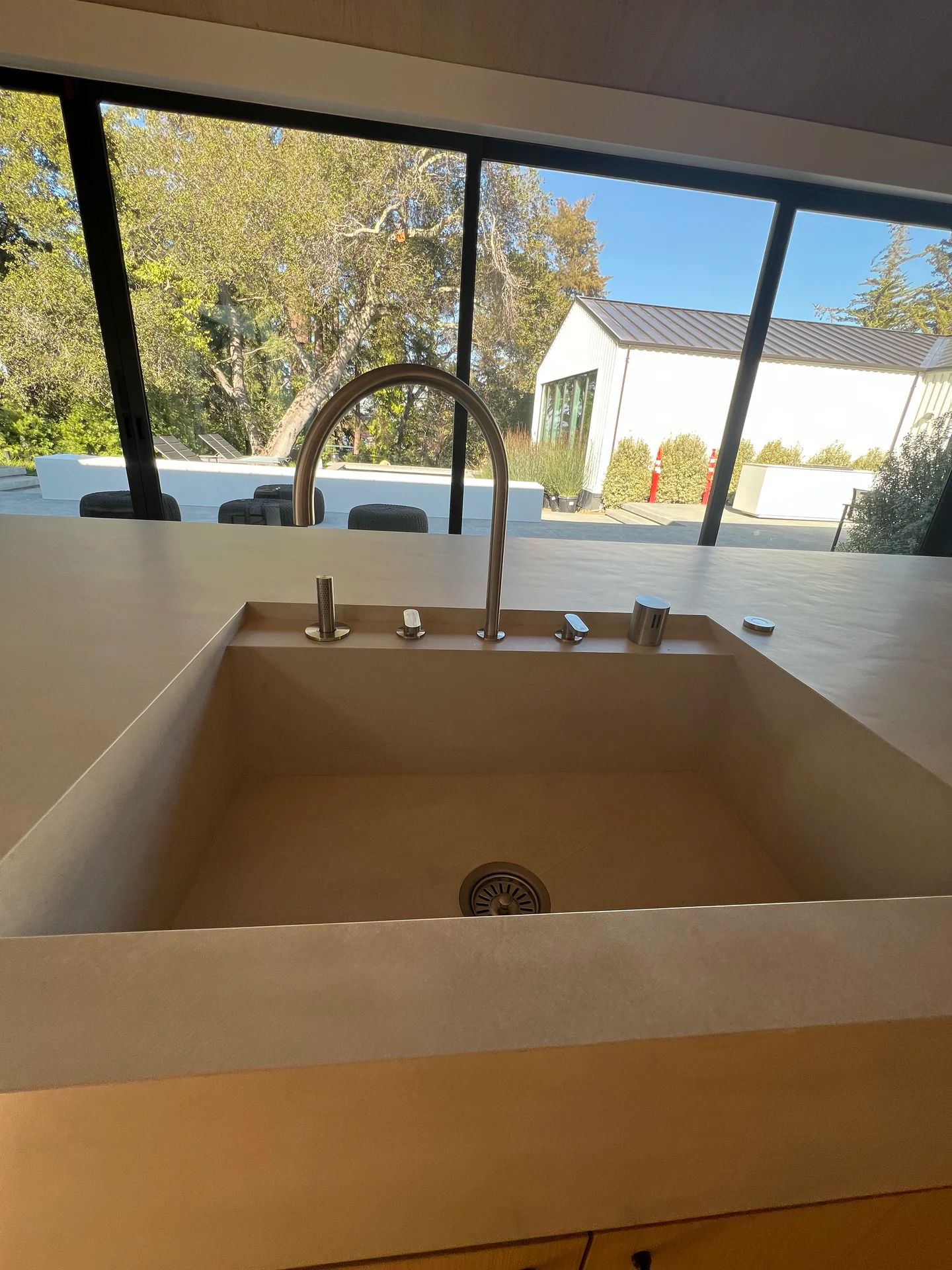 Modern kitchen sink with curved faucet — luxury kitchen by PGKB