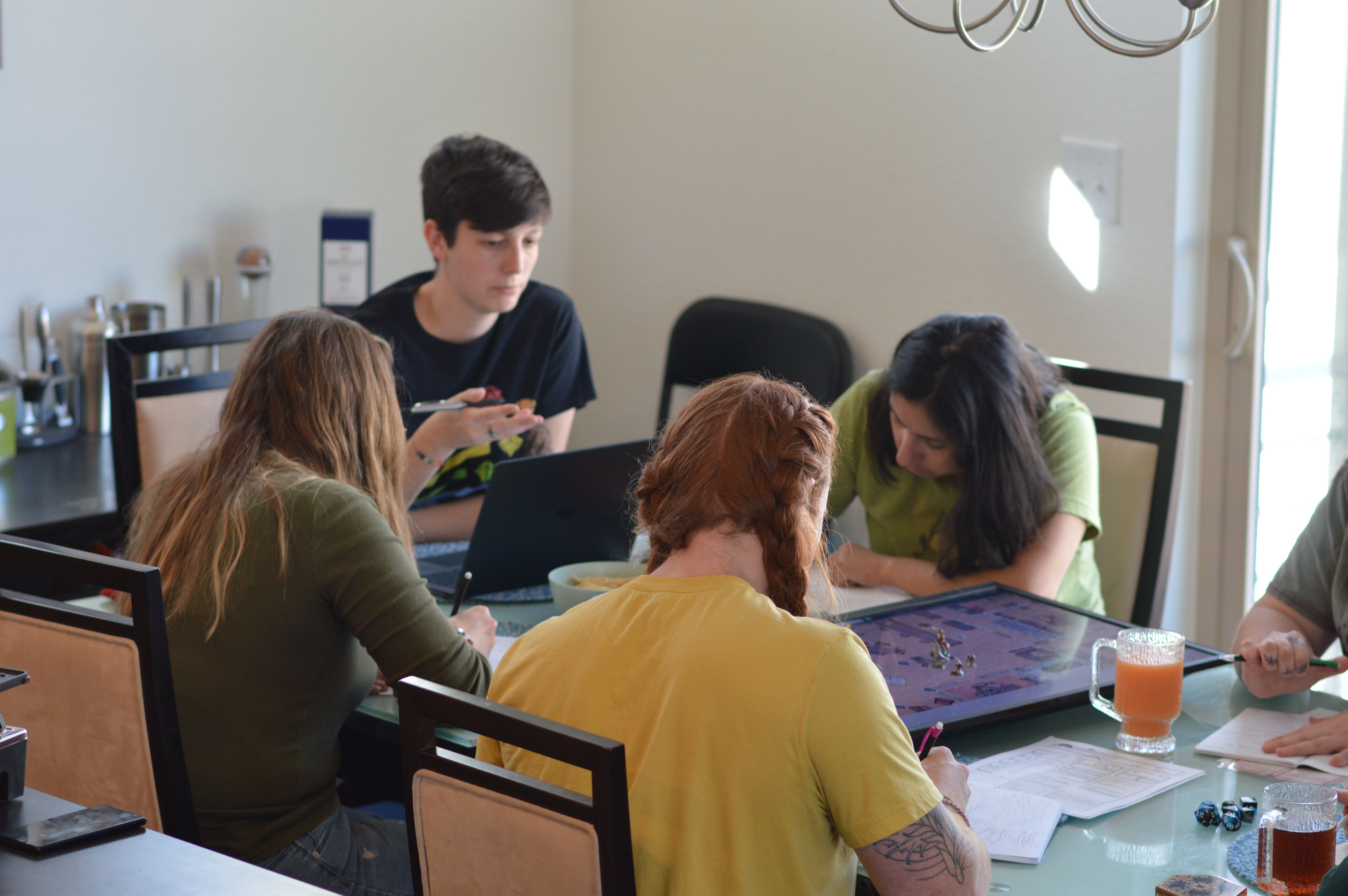 People playing Dungeons and Dragons together around a table