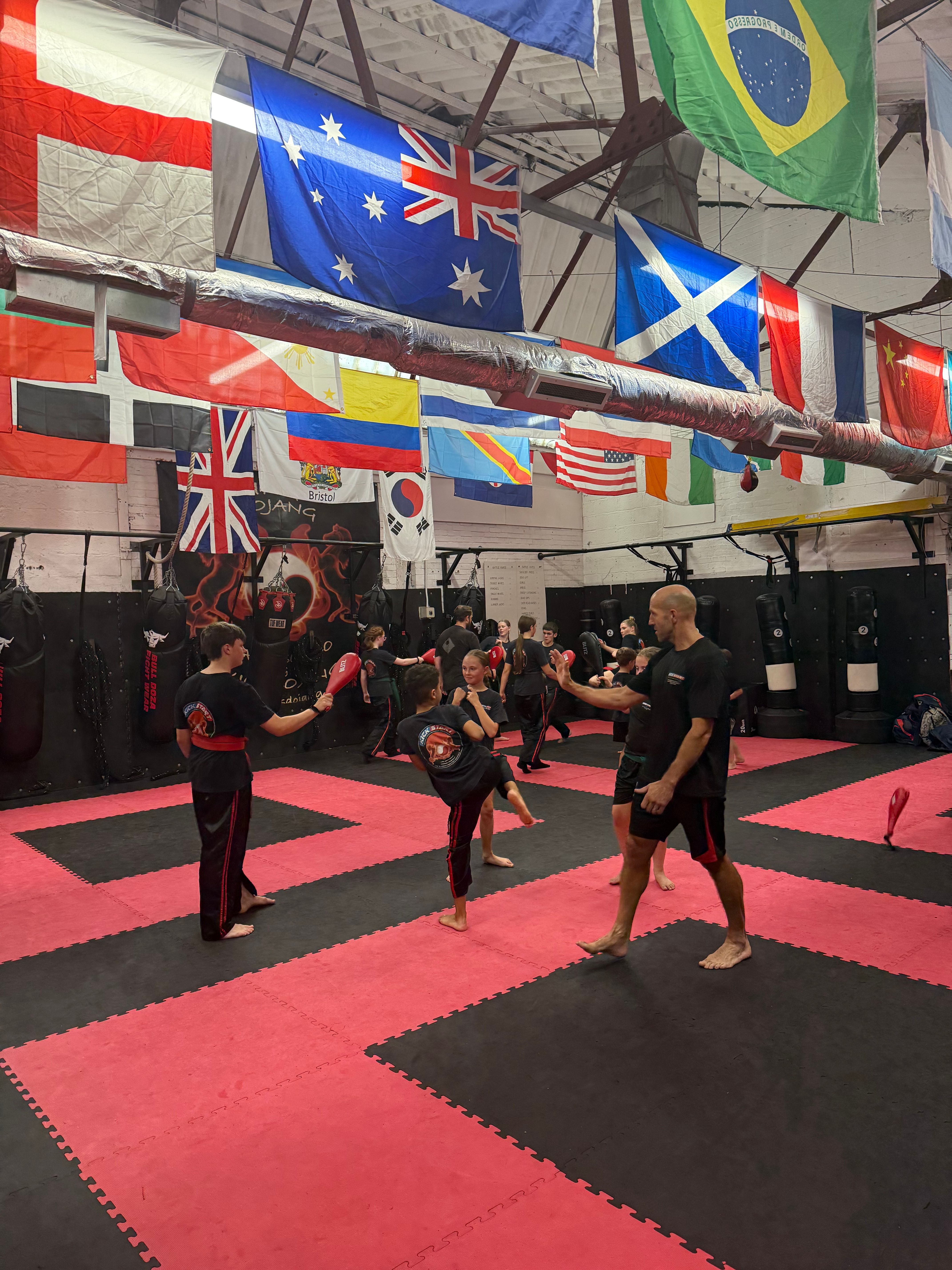 Martial arts class training with pads