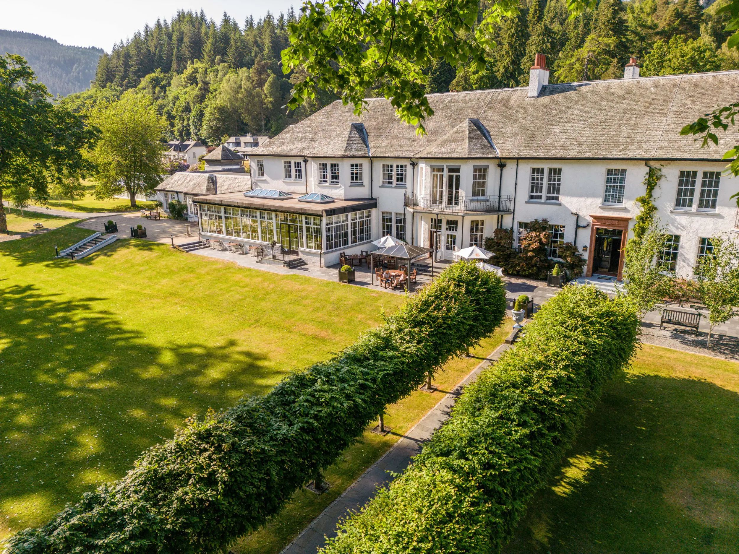 Dunkeld House Hotel exterior surrounded by woodland and River Tay — 4-star country house corporate event venue in Perthshire, Scotland